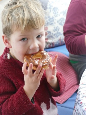 Lijah eating a chocolate-frosted donut