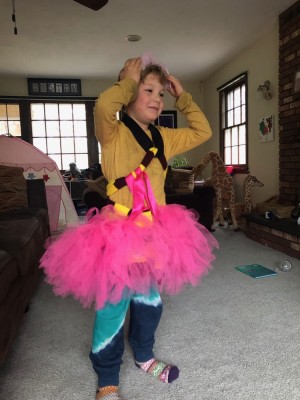 Elijah dressed up in a tutu and things at a friend's house