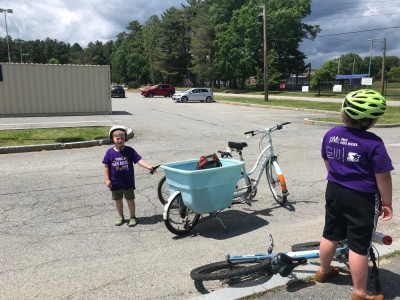 Harvey and Zion with their bikes in the empty middle school parking lot