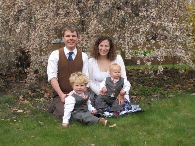 the four of us in Easter clothes in front of the flower tree