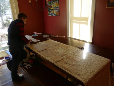 Mama pinning Easter coat patterns on the kitchen table