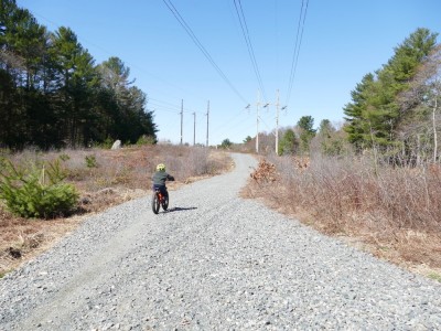 Elijah riding on a gravel road