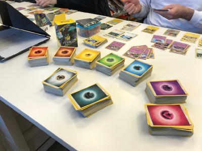 stacks Pokemon energy cards arranged by color