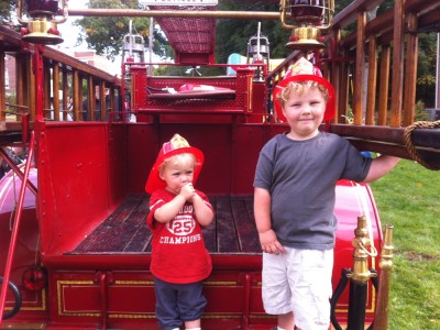 Harvey and Zion on the back of a 1911 fire truck