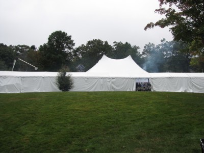 a long white tent with a tall part in the middle