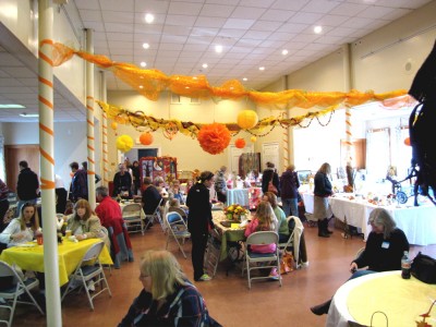 the main hall of the fair, sparkling with yellow and orange decorations