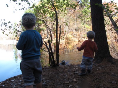 the boys on the shore of the pond, watching Rascal in the water