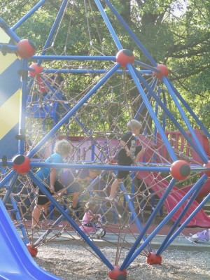 the boys playing on a playground in the evening sunshine