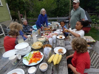 grandparents and cousins around our picnic table with lots of food