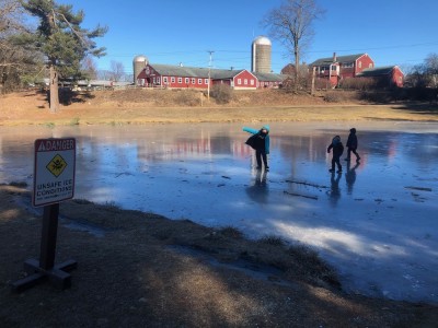 the boys playing on the ice at Great Brook Farm just by an 