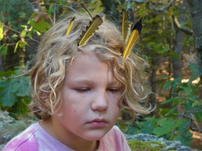 Elijah with yellow and black feathers in his hair