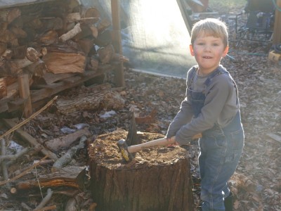 Lijah with the mallet at the firewood splitting stump