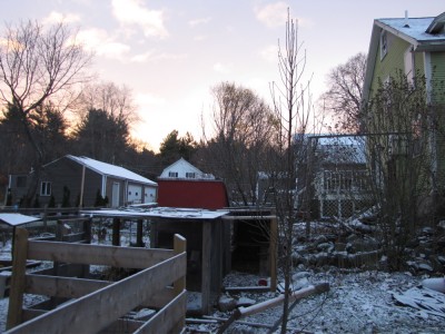 Snow on the yard and chicken coop at dawn