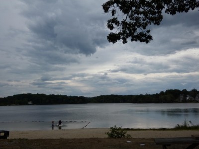 the boys swimming under dark clouds at Freeman Lake