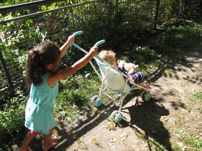 Kamila pushing Lijah in the stroller