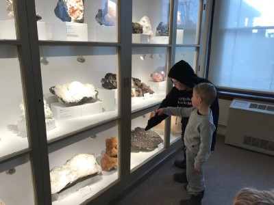 Harvey and Zion looking at minerals in a museum cabinet