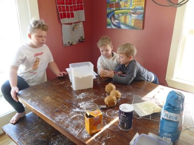 the boys rolling the dough into big balls