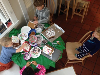 the four kids working on gingerbread houses