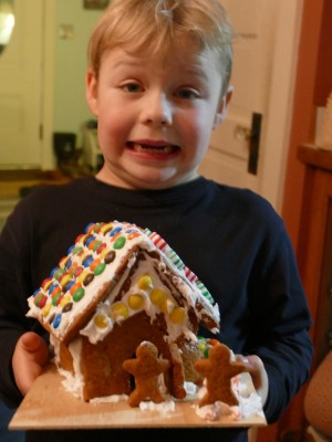 Zion holding his gingerbread house