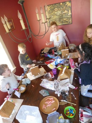 the boys and friends decorating gingerbread houses