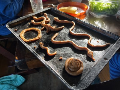 snakes and things made out of gingerbread dough waiting to be baked