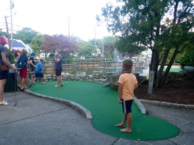 the boys playing mini golf with friends