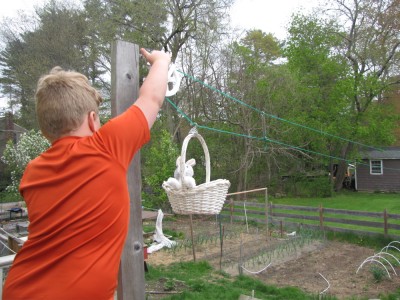 Harvey sending a stuffed animal across the clothesline in a basket