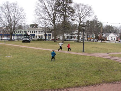 the boys running on the town green