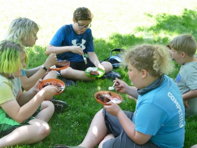 Harvey and friends eating cake and ice cream on the lawn