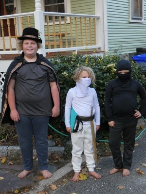 the boys in front of the house in their costumes