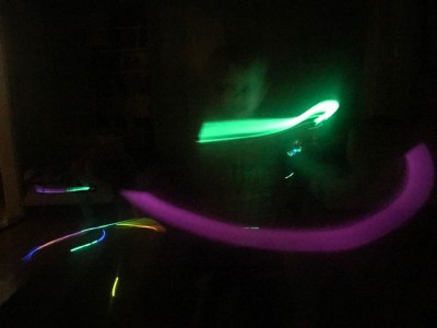 glow sticks waving in a dark room