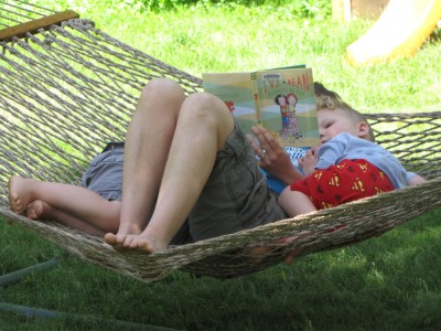 Leah reading to the littler boys on the hammock