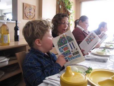 Harvey at the seder table focusing on the haggadah