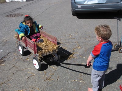 Lijah pulling a friend in a wagon hayride