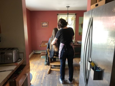 a stylist cutting a friends' hair in our kitchen