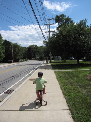 Harvey biking homeward on the sidewalk