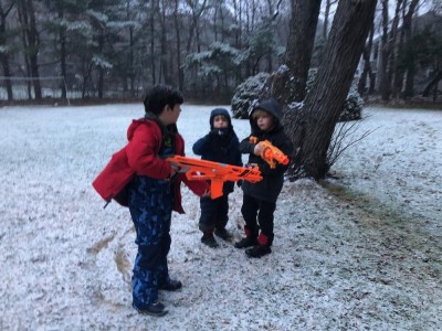 Zion, Elijah, and a friend with big orange guns in the snow