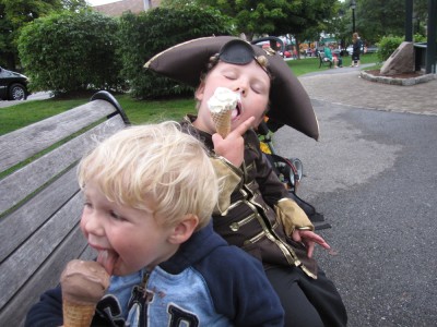 Harvey, still a pirate, and Zion eating ice cream on a park bench