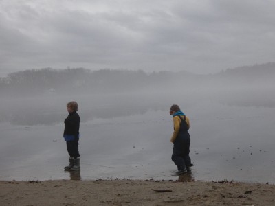 Zion and Elijah walking on water-looking ice on a misty pond