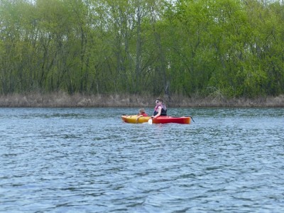 Lijah in the kayak in front of Mama