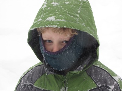 Harvey in snowsuit hood and muffler in heavy snow