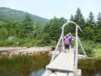 the boys crossing a timber bridge at the north end of Jordan Pond