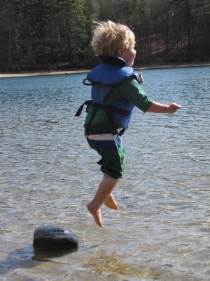 Zion airborn, leaping from a rock into very shallow water