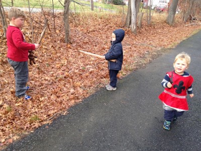 the boys looking warlike with sticks on the bike path