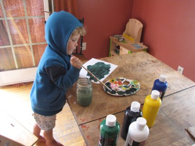 Lijah painting at the kitchen table