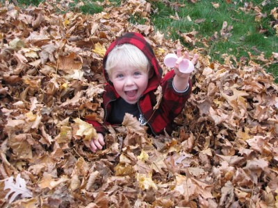 Zion delighted to have found an empty plastic egg in the leaf pile