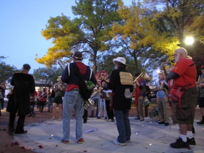 the Leftist Marching Band playing in the gathering dark