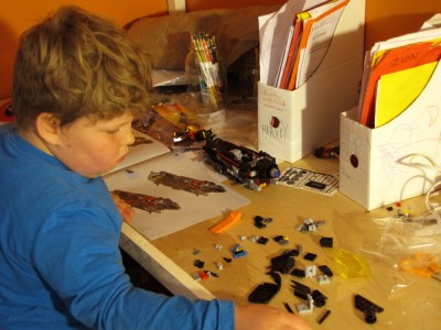 Harvey building a lego set at his desk