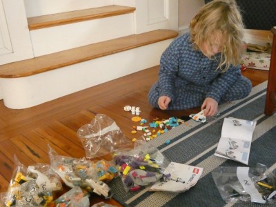 Elijah building Legos in his PJs at his grandparents' house