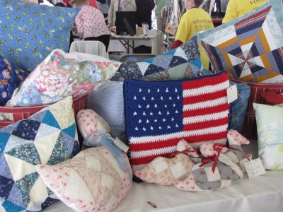 a variety of quilted crafts on display